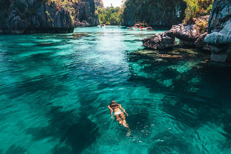 Woman swimming in clear sea water