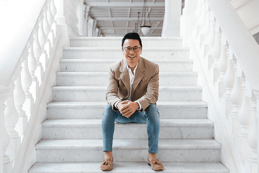 BLINK Design Group founder and creative director Clint Nagata sits on steps