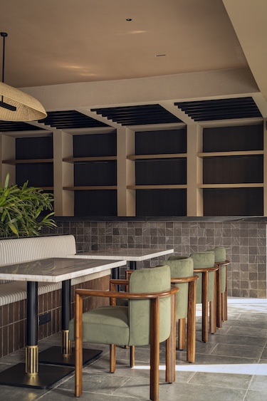 camo restaurant and bar noida india the geometric forms angular architecture earthy materials two zones terracotta green chairs