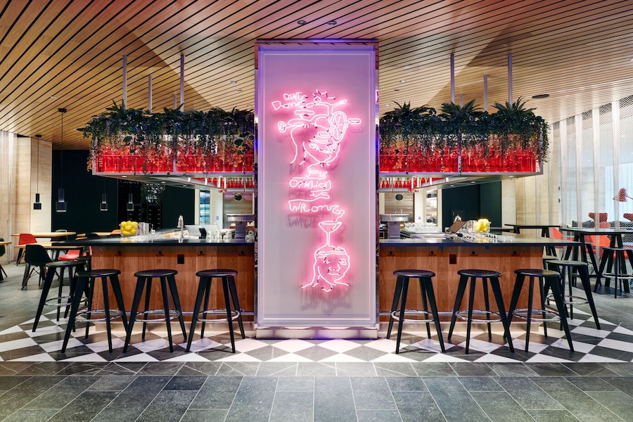 Chicago Downtown canteenM CitizenM pink neon sign black and white checkboard floors bar plants