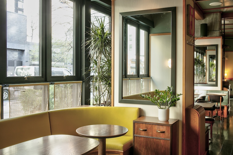 lele's roman brooklyn new york italian restaurant yellow banquette sage mirror indoor plants