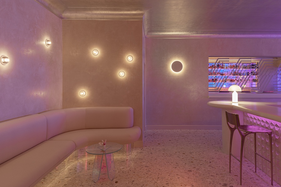 aurora lounge pdx portland international airport celestial curved furniture white walls orange purple pink lights Dichroic glass