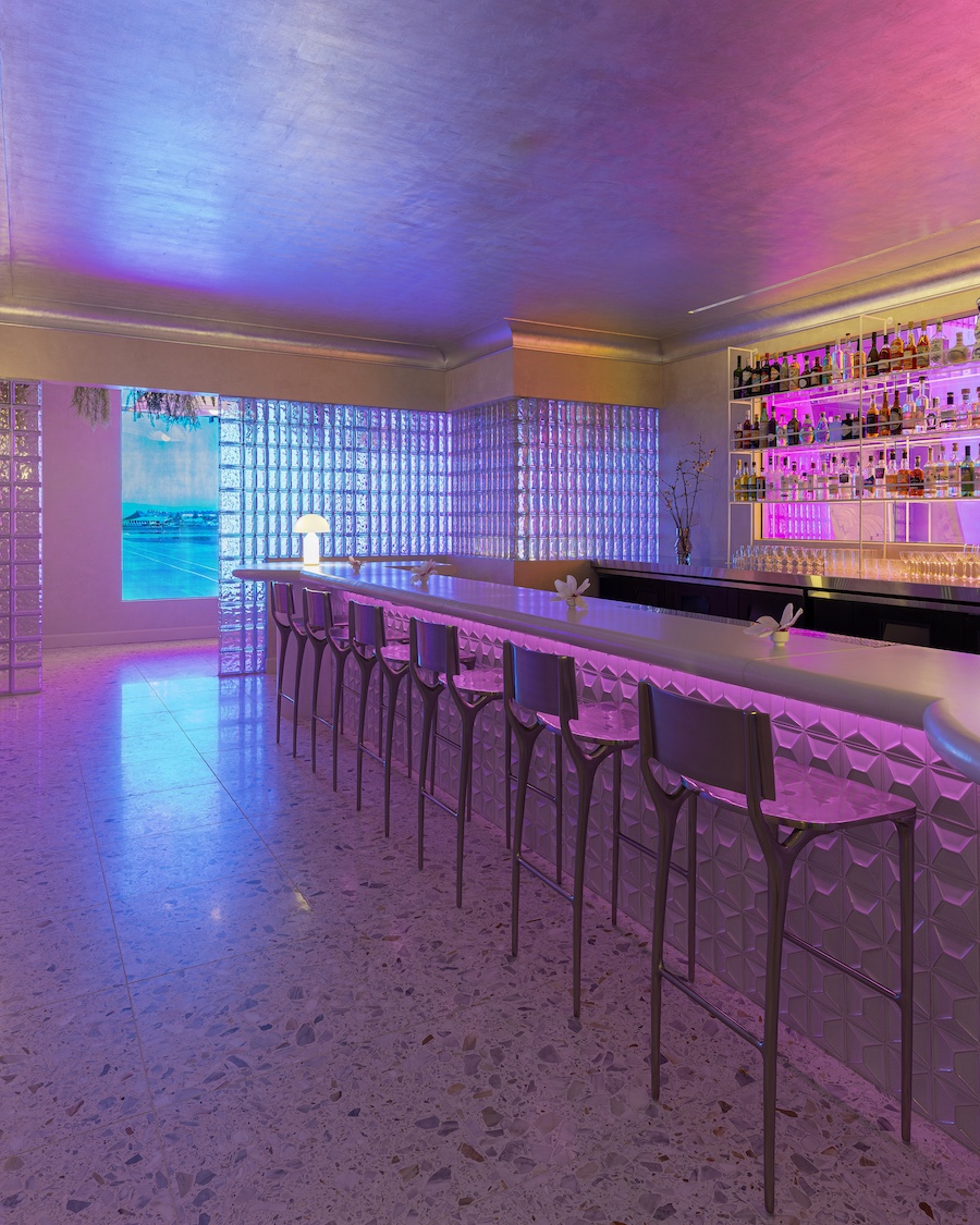 aurora lounge pdx portland international airport celestial curved furniture white walls orange purple pink lights Dichroic glass