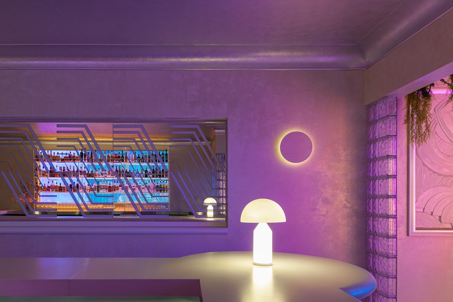 aurora lounge pdx portland international airport celestial curved furniture white walls orange purple pink lights Dichroic glass