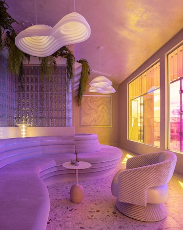 aurora lounge pdx portland international airport celestial curved furniture white walls orange purple pink lights Dichroic glass