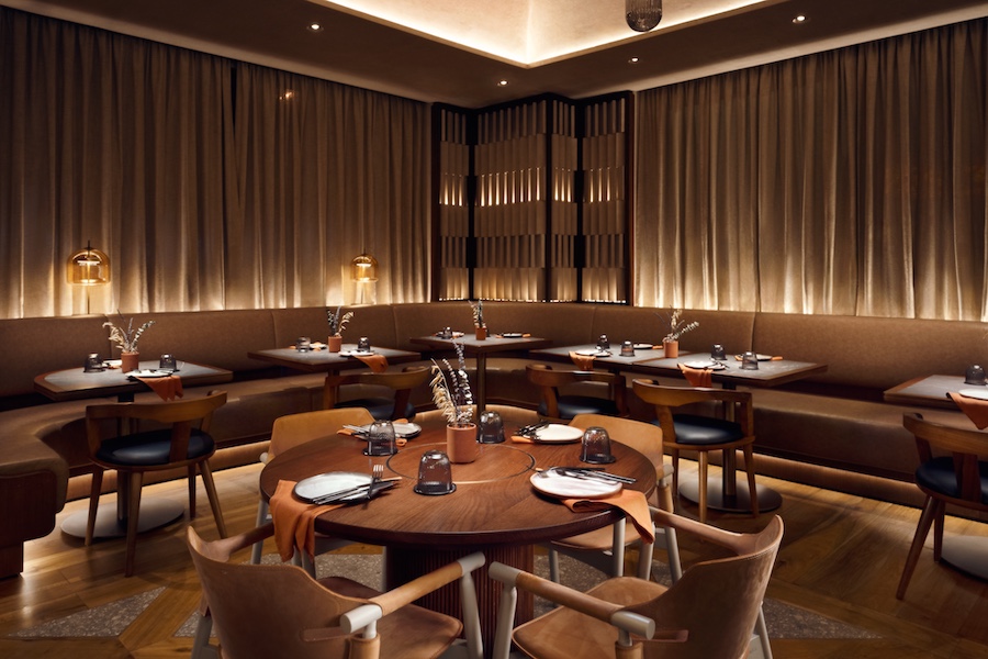 The Ninth Cut Butchery & Steakhouse in the Novotel Dubai Al Barsha hotel refined elegance wood marble main dining room underlit drapes