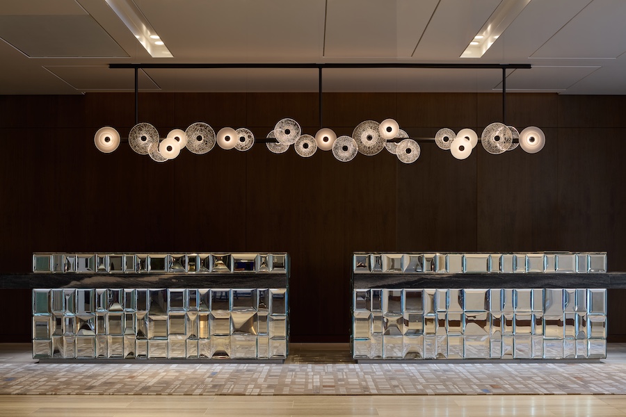 Fairmont Golden Prague Hotel Reception - Jan Černohorský a Preciosa light fixture reflective mirrored reception desk