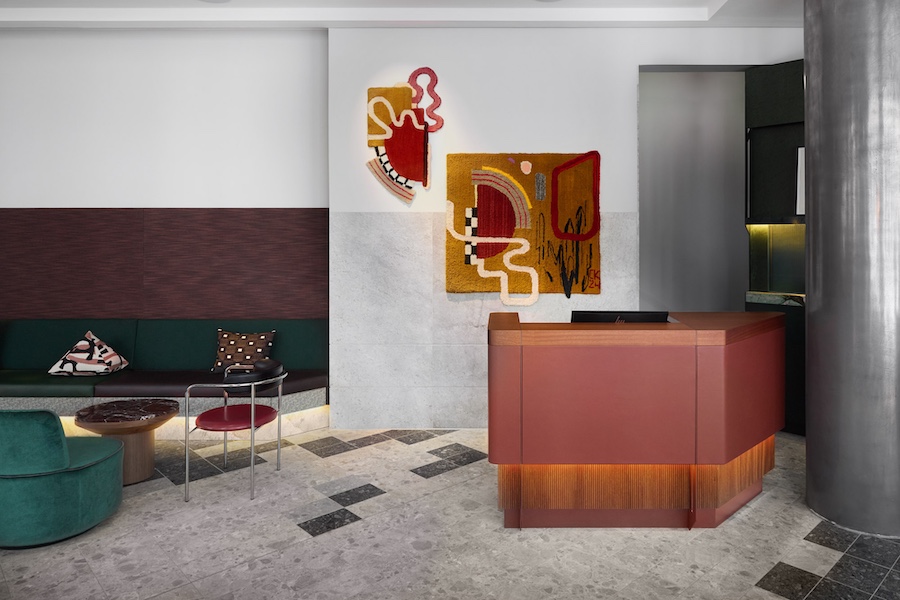 Lobby at Kimpton Main frankfurt germany bauhaus art midcentury red reception desk wall art velvet green chairs