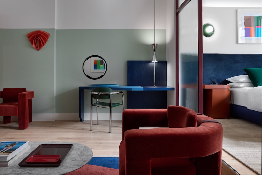 One Bedroom Suite at Kimpton Main Frankfurt germany bauhaus art blue writing desk wall art red velvet chairs