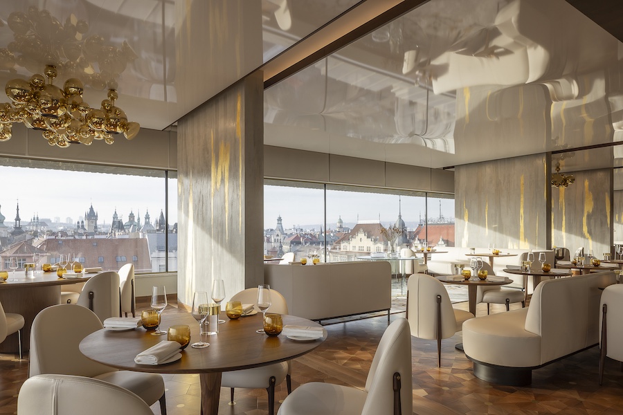 Restaurant Zlatá Praha Fairmont Golden Prague white banquettes chairs reflective ceiling golden orb installation