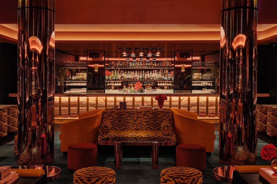 bowie supperclub speakeasy style old montreal 1980s glamour retro nightlife leopard print yellow red seating recessed ceiling lights green banquette reflective mirrored columns bar