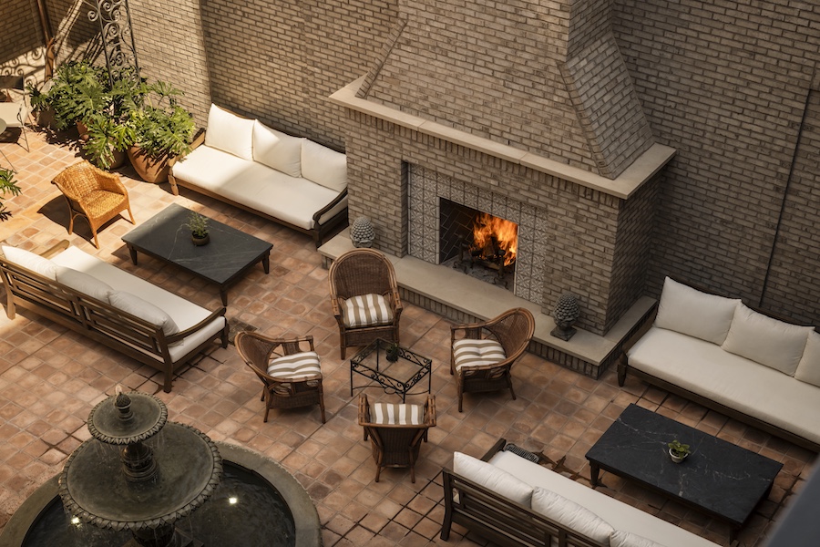 the nickel hotel charleston south carolina king street southern townhouse design courtyard striped chairs brick stone fireplace