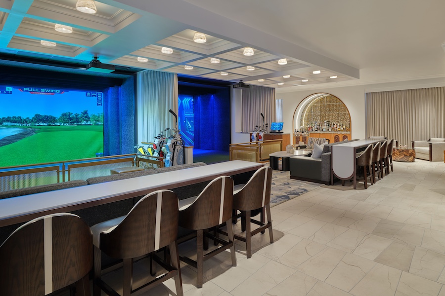 The Ritz-Carlton, Lake Tahoe Top Golf Suites simulator lounge gray chairs tables projector screen arched bar