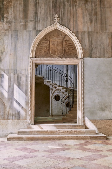 Orient Express Palazzo Donà Giovannelli grand staircase arched doorway checkered floor tiles