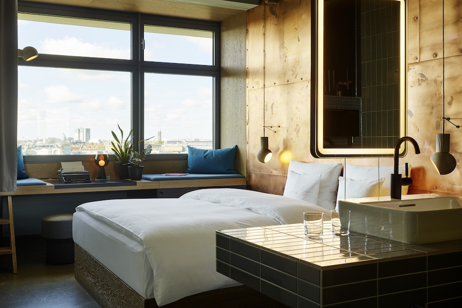 25hours hotel bikini berlin guestrooms bed copper walls green curtains open bathroom gray subway tiles