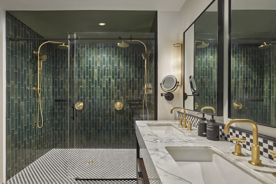 SIXTY DC guestroom bathroom emerald green shower tiles gold fixtures black and white floor tiles