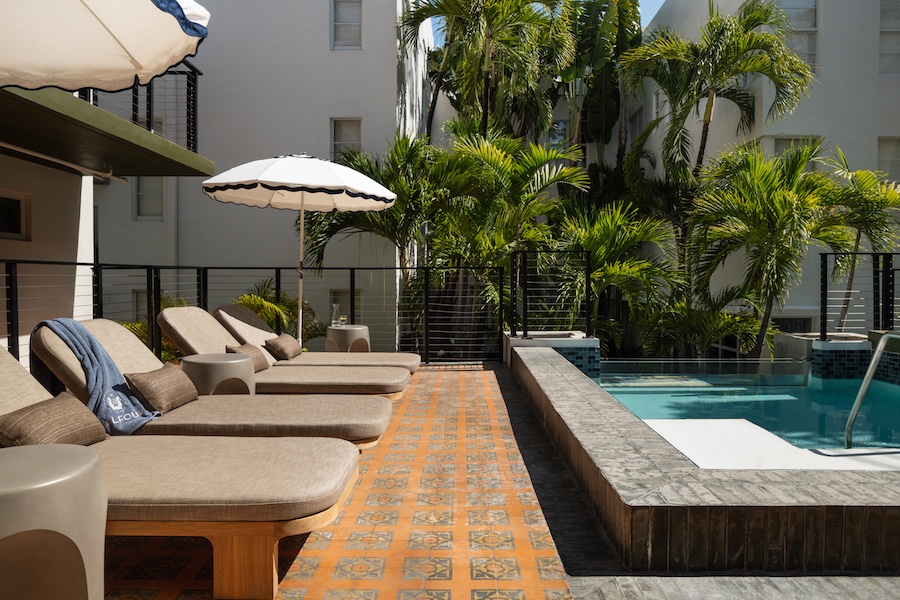 Balfour Miami Beach pool sun loungers patterned orange floor tiles palm trees