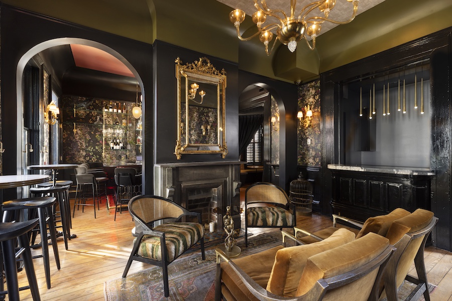 The Blackbird Hotel new orleans lower garden district french quarter old world mystique lobby black walls chandelier gilded gold frames floral wallpaper fireplace