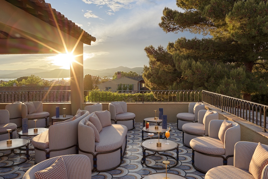 Hotel Byblos Saint-Tropez sky bar outdoor lounge blush pink seating sunset mosaic floor