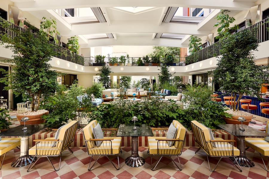w florence w lounge indoor courtyard trees plants atrium yellow white striped chairs checkered flooring