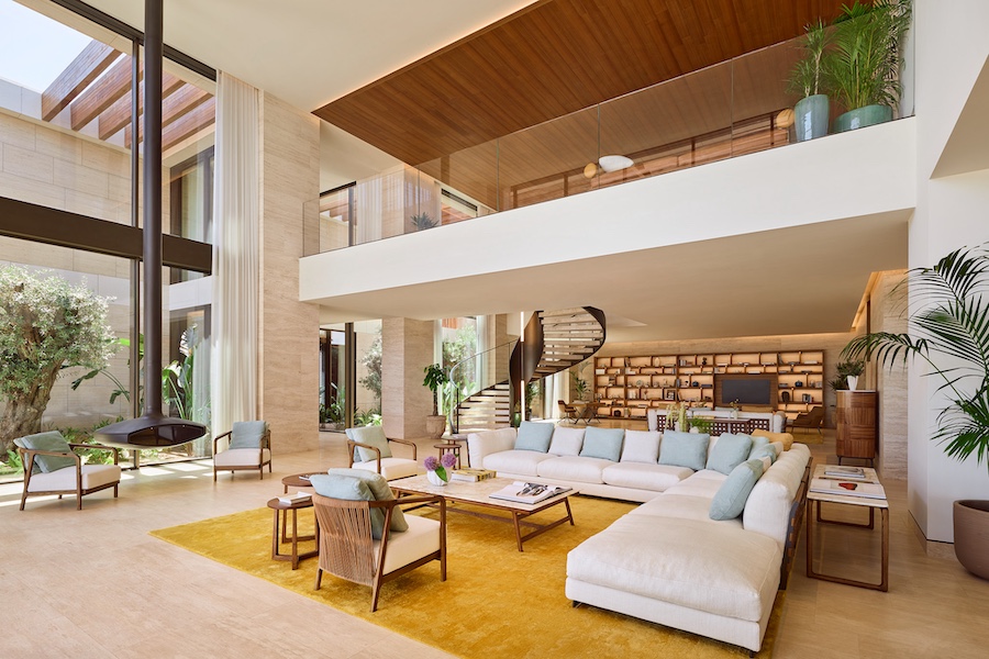 Bvlgari Resort and Mansions Bodrum living room double height spiral staircase white couch blue pillows wood ceiling