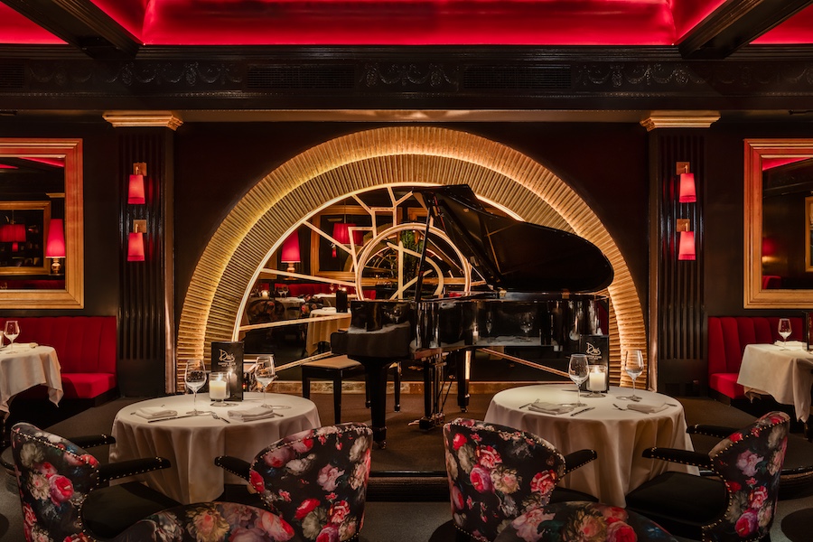 Drais Supper Club new york chelsea meatpacking jazz lounge red banquettes floral chairs red uplighting grand piano arch stage