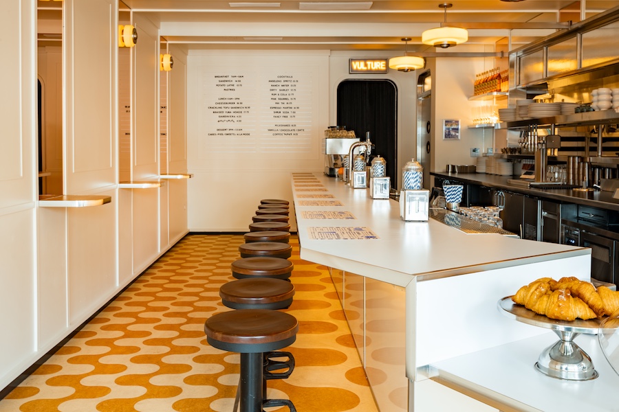 dreamboat cafe desserts sweets bright airy light vertical white tiles orange white patterned flooring bar stools