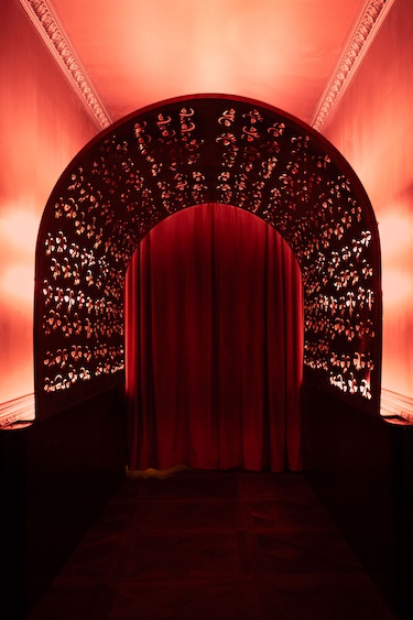 maison nur lower east side manhattan new york restaurant lounge night club entrance hallway arch red lighting red curtains