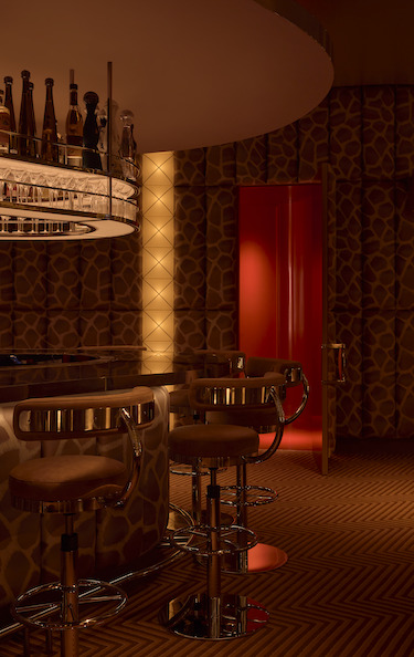 Obvio modern supper club cocktail bar Manhattan new york cinematic interiors padded walls giraffe print brocade vertical lights bar stool