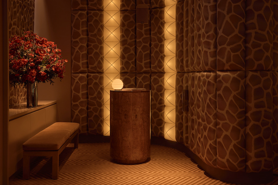 Obvio modern supper club cocktail bar Manhattan new york cinematic interiors padded walls giraffe print brocade vertical lights round host stand red flower bouquet