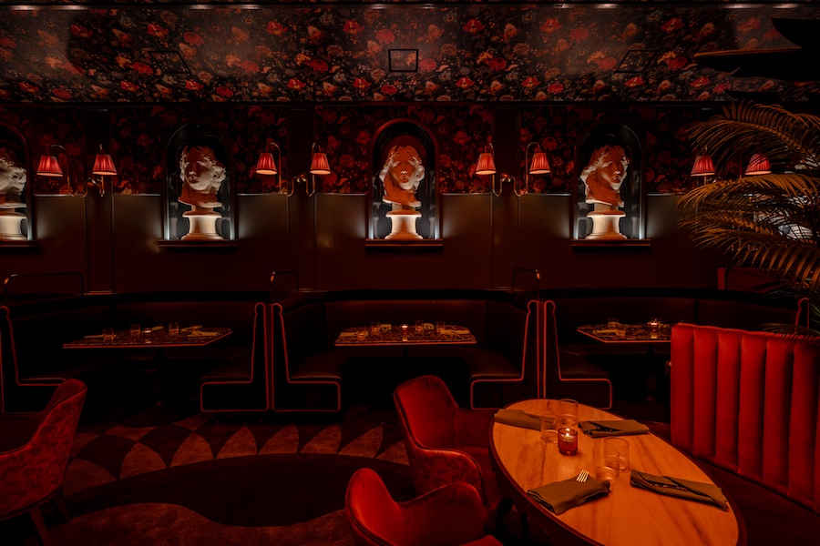 vulture san diego neoclassical moody restaurant floral wallcovering red banquettes statue busts booth seating