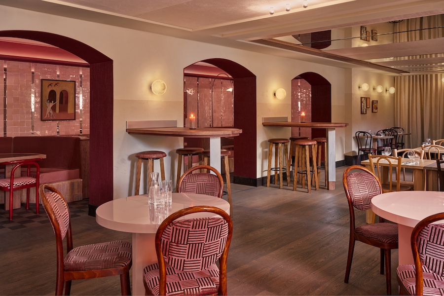 vertigo cafe Amsterdam Vondelpark Pavilion alfred hitchcock movie maining dining room red pink palette striped pattern bistro chairs arched doorways bar height tables stools