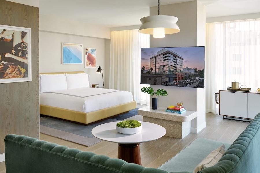 the hollywood grande los angeles former thompson hotel midcentury design guestroom suite yellow bed tv teal banquette seating wall art