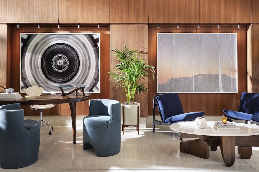 the hollywood grande los angeles former thompson hotel midcentury design lobby bar fluted glass chandeliers concierge desk blue side chairs wall art wood walls indoor plant