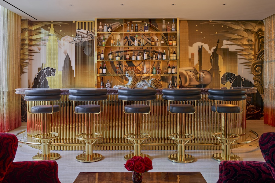 faena new york hotel bar fluted gold bar face black leather stools