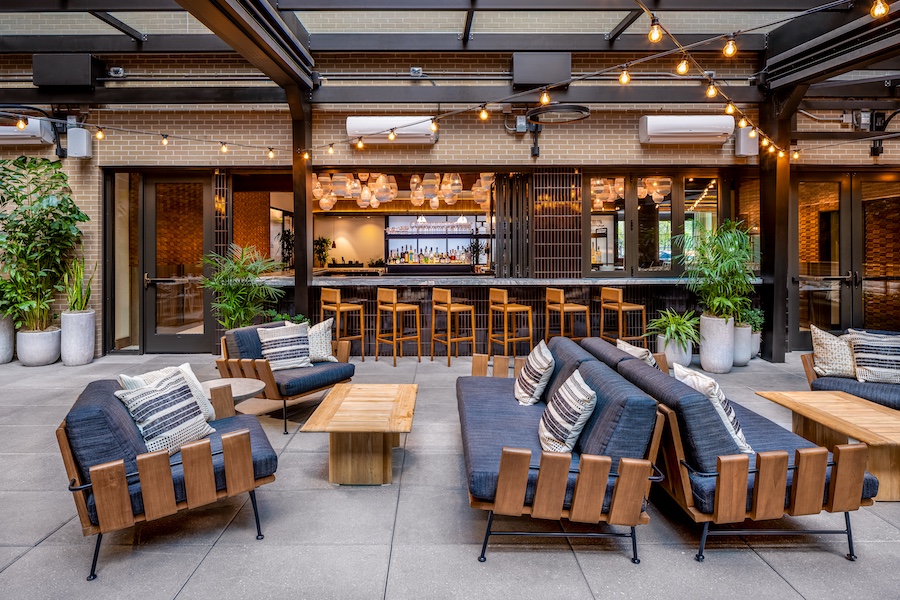 arrels restaurant arlo hotel washington dc spanish heritage outdoor patio string lights blue chairs bar black tile