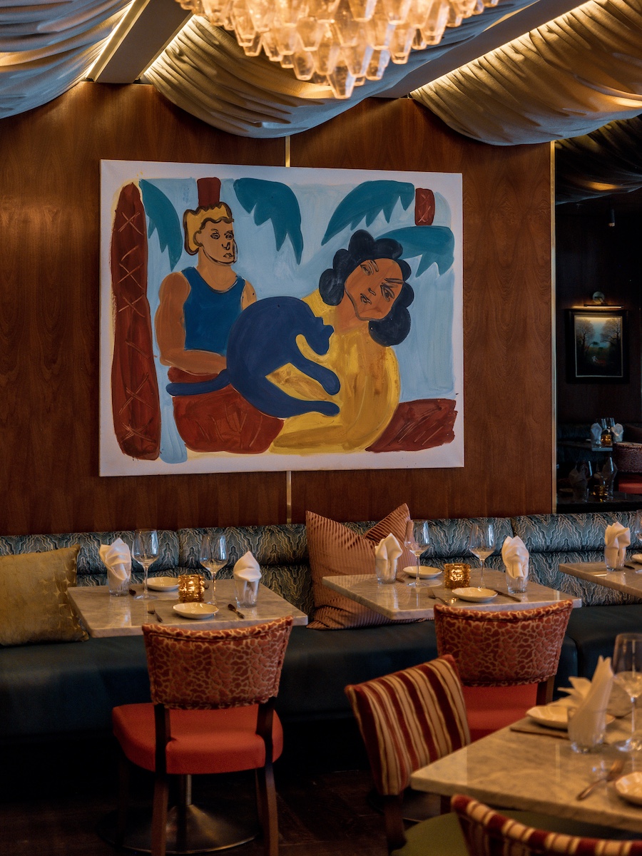 Sirrah new york meatpacking district french maximalism wall art orange chairs
