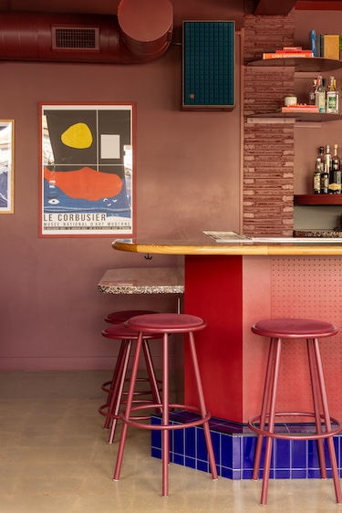semiprecious bar denver oxblood red bar stools cobalt blue lapis lazuli chairs wood panel walls wall art