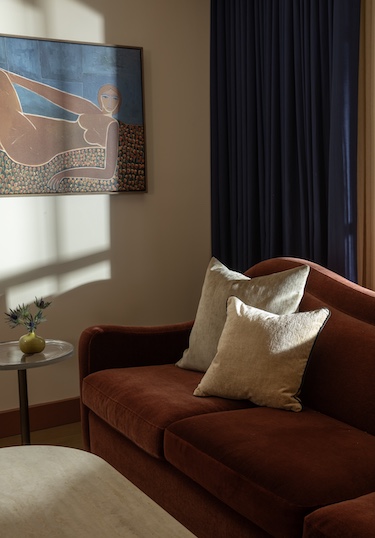 hotel daphne houston texas white pillow cushions brown sofa wall art woman