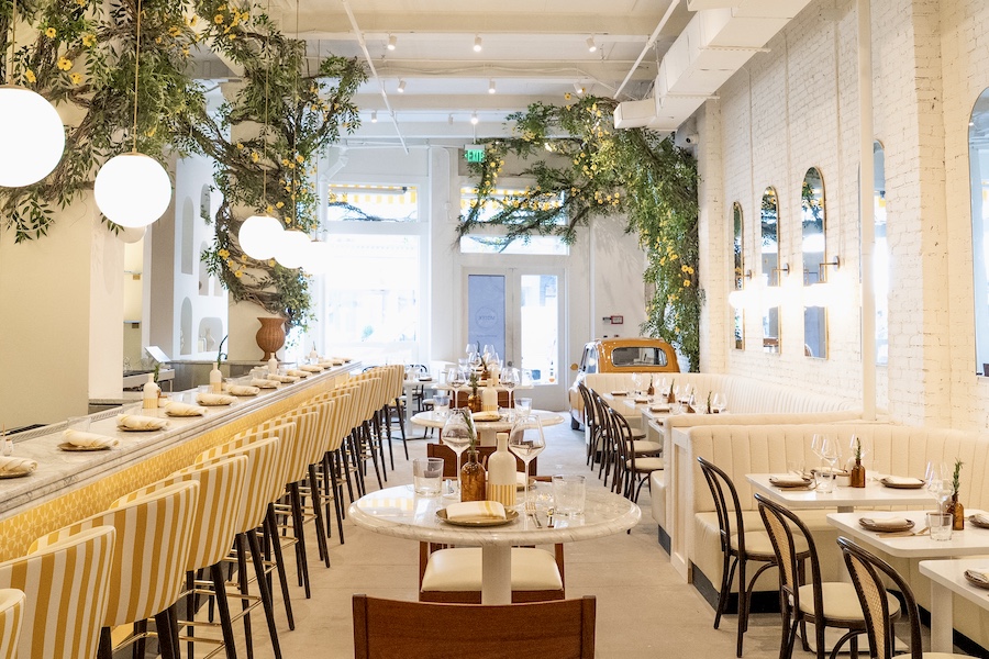 Motek new york manhattan flatiron mediterranean design white interiors yellow accents chairs arched seating niches indoor plants