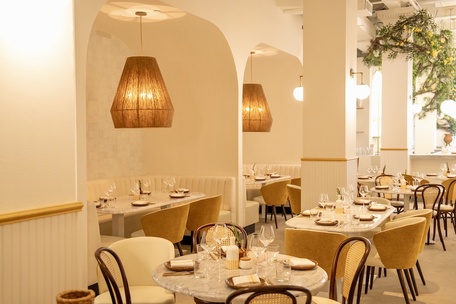 Motek new york manhattan flatiron mediterranean design white interiors yellow accents chairs arched seating niches indoor plants