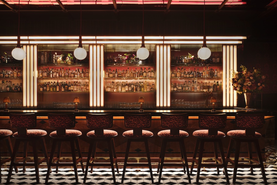 carbone london major food group mfg ken fulk wall mural white tablecloths red ceiling black and white checkerboard floor backlit bar stools