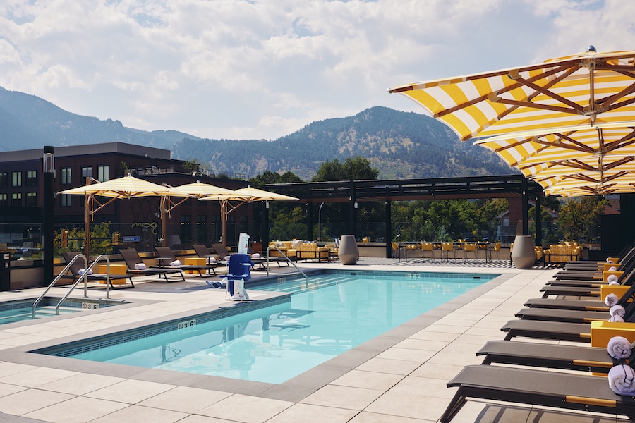 limelight boulder university of colorado boulder all electric sustainable hotel mountains pool yellow white striped umbrellas
