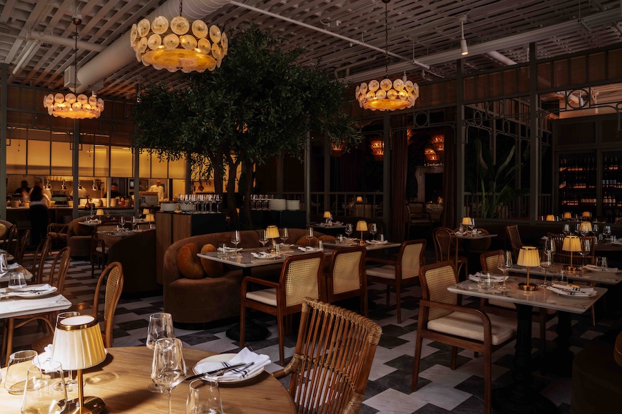 Macarena restaurant silicon valley main dining room statement chandeliers latticed ceiling rattan chairs black and white floor indoor tree plant