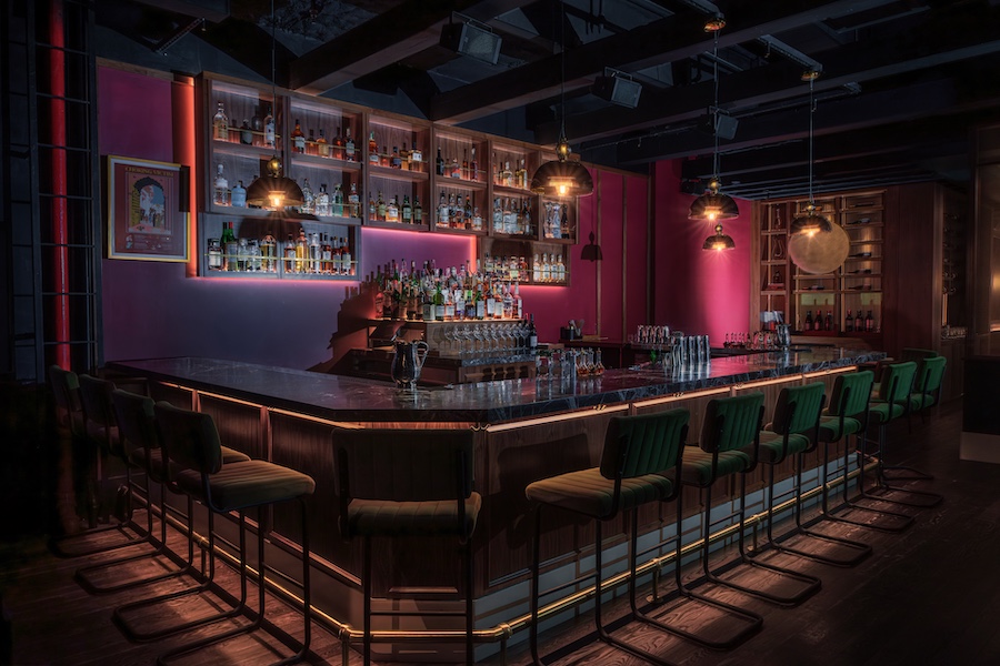 passerine bar new york manhattan flatiron indian restaurant jewel tones velvet green barstools burgundy wall paint hanging light pendants liquor shelf bar
