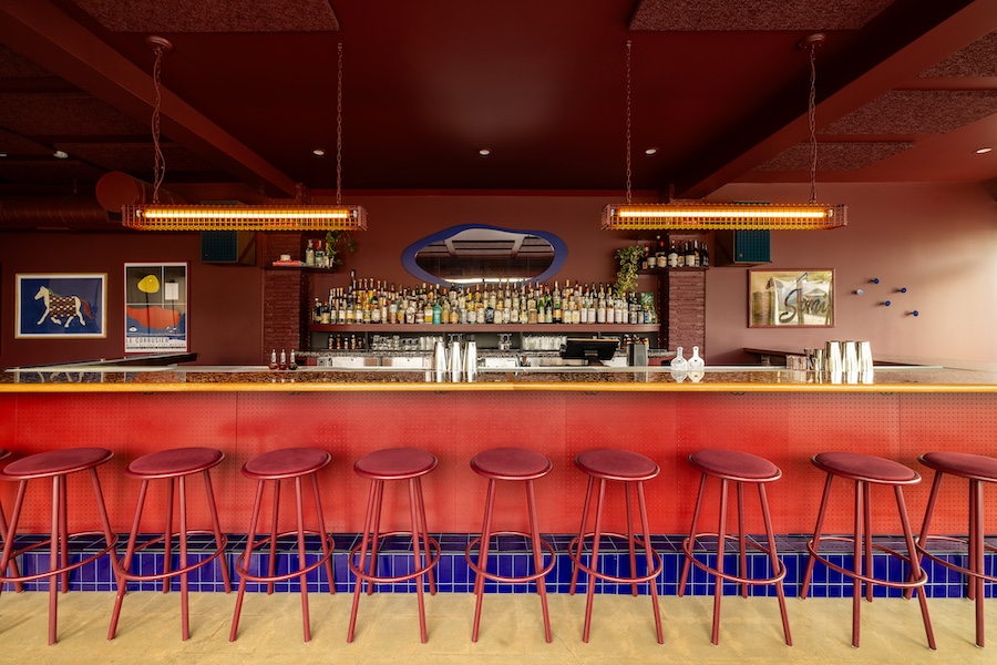semiprecious bar denver oxblood red bar stools cobalt blue lapis lazuli chairs wood panel walls