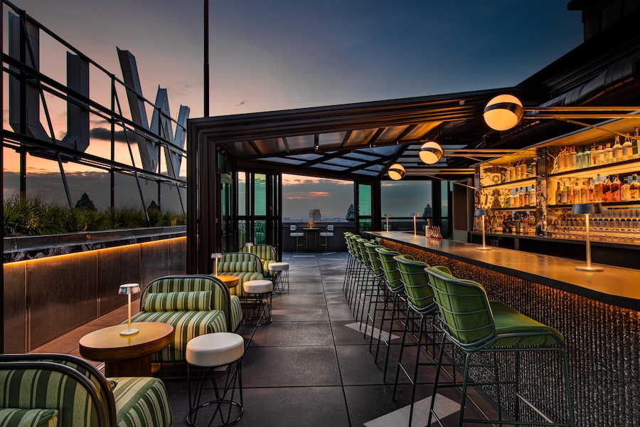 W New York – Union Square The Rooftop green bar stools striped lounge chairs marquee sign
