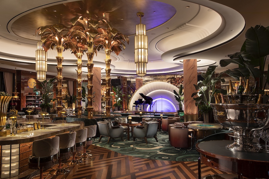 Wynn Al Marjan Island Delilah restaurant recessed ceiling lights leopard print armchairs blue velvet bar