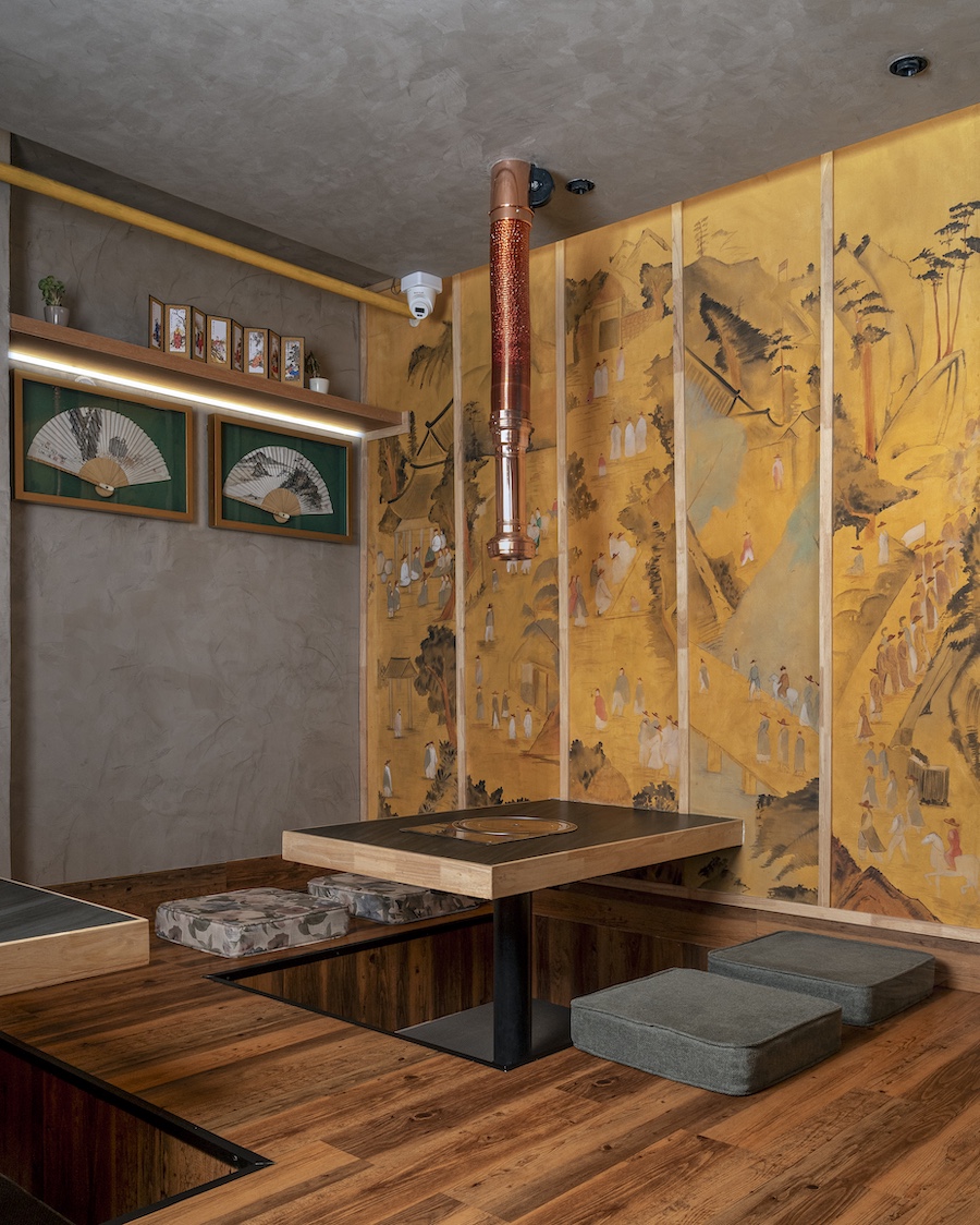 seoul restaurant new delhi korean dining japandi design scandanavian minimalism wood yellow wall mural vent sunken seating nook