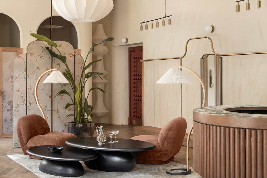 love by the moon kyiv boutique clothing retail store light oak wood white sheer curtains check out reception desk fluted wood millwork white jellyfish light black coffee tables velvet brown armchairs indoor plant